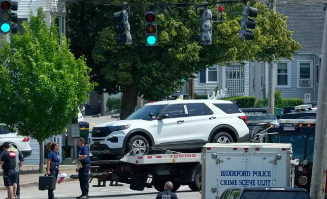 A vehicle is transported on a flatbed near the scene of a shooting involving U.S. Immigration and Customs Enforcement, Monday, July 13, 2026 in Biddeford, Maine. (AP Photo/Robert F. Bukaty)