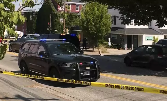 This image taken from video provided by WMTW shows police on the scene after a shooting involving U.S. Immigration and Customs Enforcement, Monday, July 13, 2026 in Biddeford, Maine. (WMTW via AP)