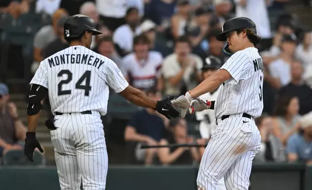 Chicago White Sox's Munetaka Murakami, right, celebrates with teammate Braden Montgomery (24) after scoring on a Chase Meidroth sacrifice fly during the first inning of a baseball game against the New York Yankees in Chicago, Monday, July 27, 2026. (AP Photo/Paul Beaty)