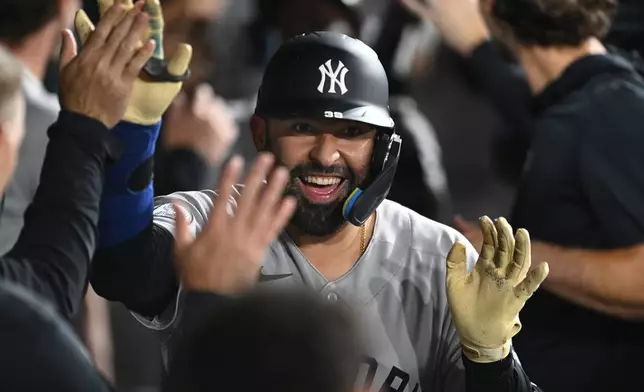 New York Yankees' Ali Sanchez celebrates with teammates in the dugout after hitting a three-run home run during the eighth inning of a baseball game against the Chicago White Sox in Chicago, Monday, July 27, 2026. (AP Photo/Paul Beaty)