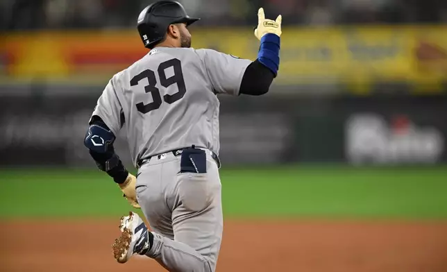 New York Yankees' Ali Sanchez celebrates after hitting a three-run home run during the eighth inning of a baseball game against the Chicago White Sox in Chicago, Monday, July 27, 2026. (AP Photo/Paul Beaty)