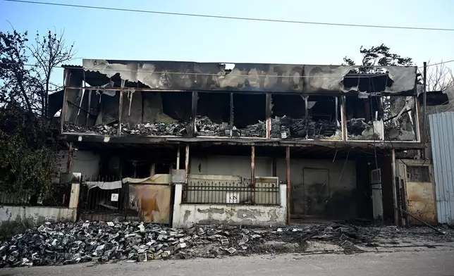 A view of a burnt building from a wildfire on the outskirts of the northern city of Thessaloniki, Greece, Sunday, July 5, 2026. (AP Photo/Giannis Papanikos)