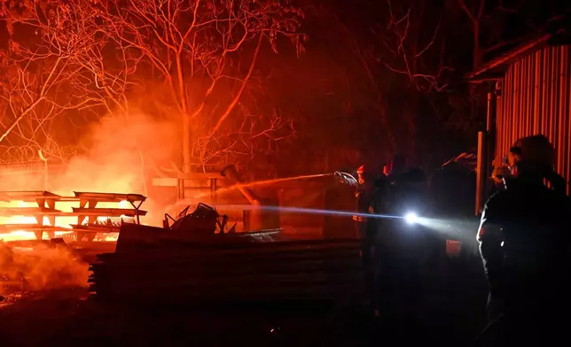 Firefighters work on a wildfire on the outskirts of the northern city of Thessaloniki, Greece, Saturday, July 4, 2026. (AP Photo/Giannis Papanikos)
