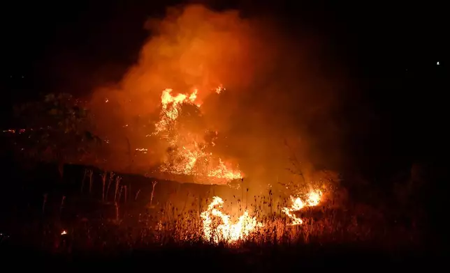 Wildfires burn on the outskirts of the northern city of Thessaloniki, Greece, Saturday, July 4, 2026. (AP Photo/Giannis Papanikos)