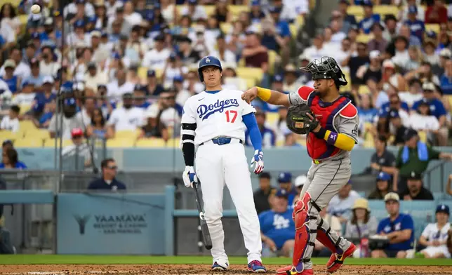Los Angeles Dodgers' Shohei Ohtani (17) reacts as Arizona Diamondbacks catcher Gabriel Moreno throws during the third inning of a baseball game in Los Angeles, Sunday, July 12, 2026. (AP Photo/Kyusung Gong)