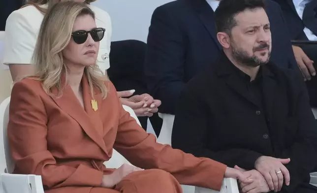 Ukraine's President Volodymyr Zelensky and his wife Olena Zelenska attend the Bastille Day military parade on the Champs-Elysees avenue, in Paris, Tuesday, July 14, 2026. (AP Photo/Michel Euler)