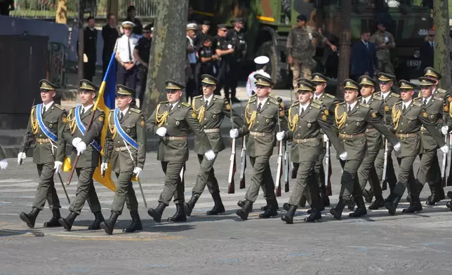 Ukrainian soldiers march during the Bastille Day military parade on the Champs-Elysees avenue, in Paris, Tuesday, July 14, 2026. (AP Photo/Michel Euler)