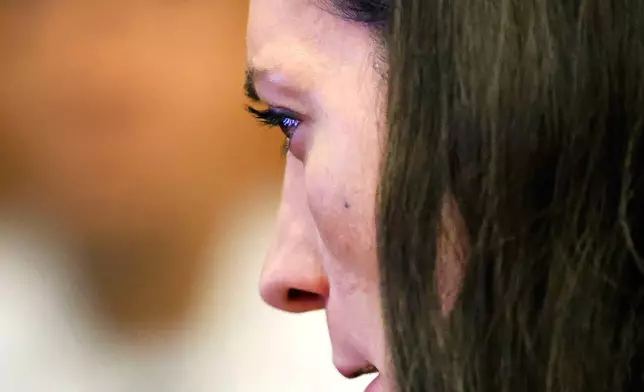 Lindsay Clancy cries as she sees images of herself with her children playing at a indoor waterpark a month before they were killed during her trial in the Plymouth Superior Court in Plymouth, Mass., Monday, July 27, 2026. (Greg Derr/The Patriot Ledger via AP, Pool)