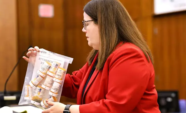 Jennifer Sprague, a prosecutor with the Plymouth County District Attorney's Office, enters a bag of prescription pills as evidence in Lindsay Clancy's trial, Monday, July 27, 2026, at Plymouth Superior Court in Plymouth, Mass. (Greg Derr/The Patriot Ledger via AP, Pool)
