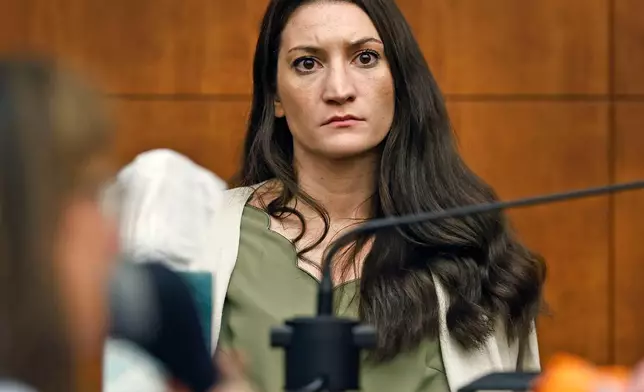 Lindsay Clancy waits for the judge to call a prospective jury member into court in her murder trial where she is charged in the 2023 killing of her three children, Wednesday, July 22, 2026, in Plymouth Superior Court in Plymouth, Mass. (Greg Derr/The Patriot Ledger via AP, Pool)