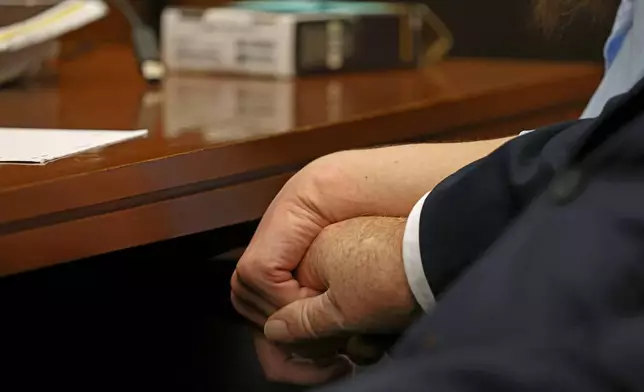 Defense attorney Kevin Reddington holds the hand of Lindsay Clancy while listening to the 911 recording from Jan. 24, 2023, during Clancy's murder trial at Plymouth Superior Court in Plymouth, Mass., on Wednesday, July 29, 2026. (David L. Ryan/The Boston Globe via AP, Pool)