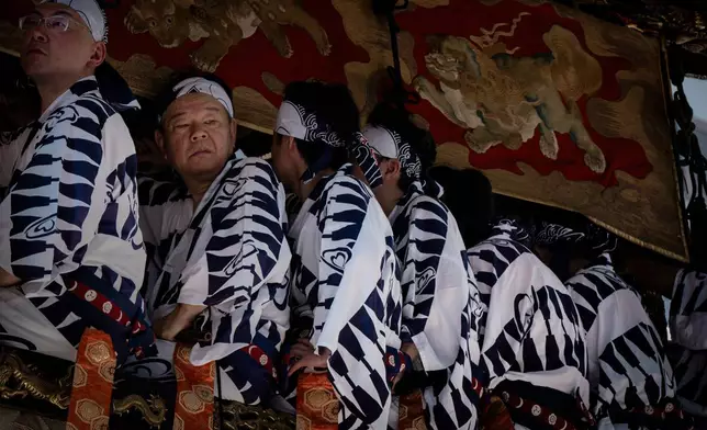 Musicians are seen atop a festival float during one of the main parades of Shinto's Gion Matsuri festival in Kyoto, western Japan, Friday, July 17, 2026. (AP Photo/Fred Mery)