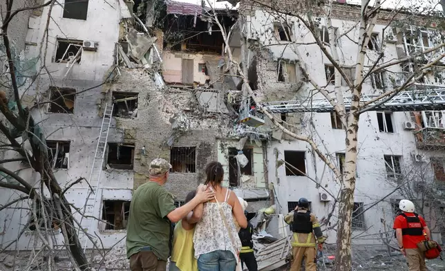 Residents look at their ruined home following a Russian air guided bomb strike in Zaporizhzhia, Ukraine, Sunday, July 19, 2026. (AP Photo/Kateryna Klochko)