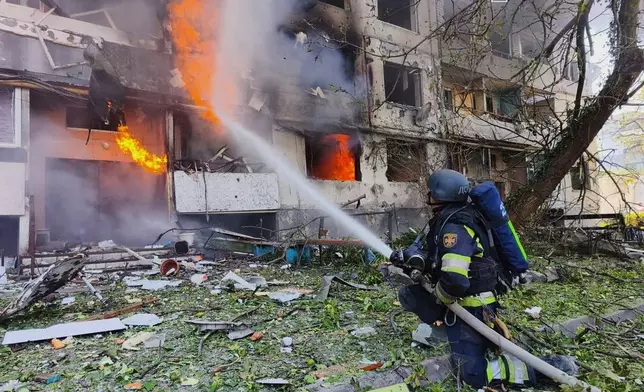 In this photo provided by the Ukrainian Emergency Service, firefighters put out a fire in a residential building following a Russian air attack in Pavlohrad, Dnipropetrovsk region, Ukraine, Monday, July 20, 2026. (Ukrainian Emergency Service via AP)