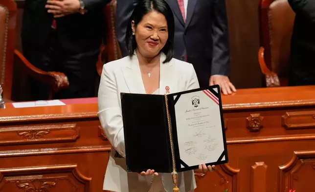 Peruvian President-elect Keiko Fujimori shows her credentials from the National Elections Board during a ceremony in Lima, Peru, Wednesday, July 15, 2026. (AP Photo/Martin Mejia)