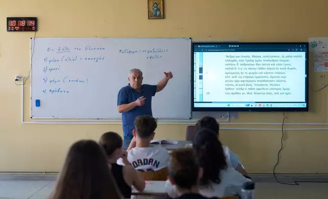 Teacher Filippos Mantzaris leads a lesson on Homer's Odyssey for seventh-grade students at a Gymnasio (middle school) in the Athens suburb of Tavros, Wednesday, May 27, 2026. (AP Photo/Petros Giannakouris)