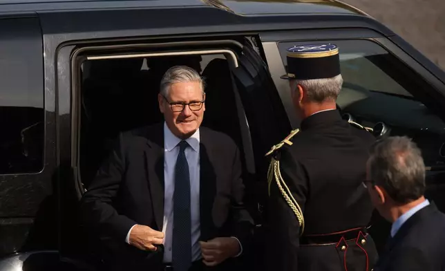 British Prime Minister Keir Starmer arrives for the Bastille Day military parade on the Champs-Elysees avenue in Paris, Tuesday, July 14, 2026. (AP Photo/Thomas Padilla)