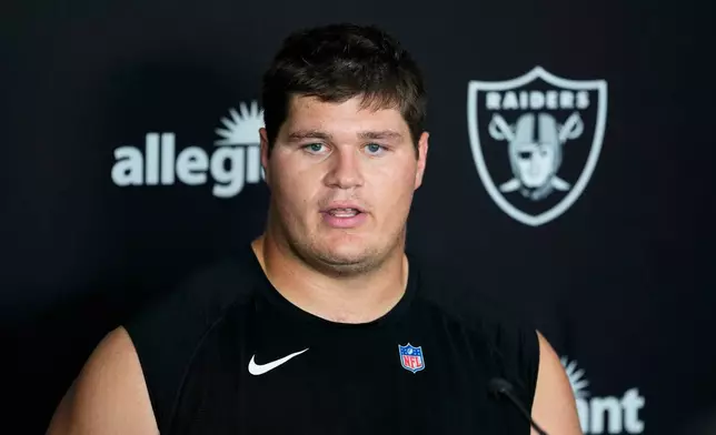 Las Vegas Raiders center Tyler Linderbaum (65) speaks during a news conference at the team's NFL football training camp, Wednesday, July 29, 2026, in Henderson, Nev. (AP Photo/Lucas Peltier)