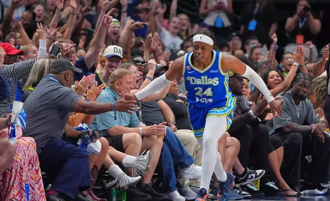 Dallas Wings guard Arike Ogunbowale (24) celebrates after scoring a 3-point basket during the first half of a WNBA basketball game against the Chicago Sky in Dallas, Sunday, July 12, 2026. (AP Photo/LM Otero)