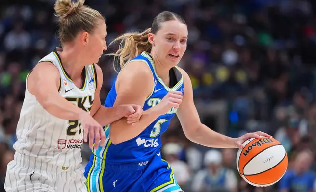 Dallas Wings guard Paige Bueckers, right, drives against Chicago Sky guard Courtney Vandersloot, left, during the second half of a WNBA basketball game in Dallas, Sunday, July 12, 2026. (AP Photo/LM Otero)