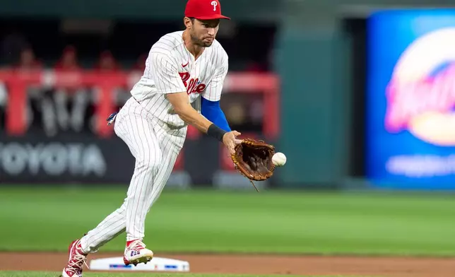 Philadelphia Phillies shortstop Trea Turner fields the ground ball by Los Angeles Dodgers' Freddie Freeman during the first inning of a baseball game, Tuesday, July 21, 2026, in Philadelphia. (AP Photo/Chris Szagola)