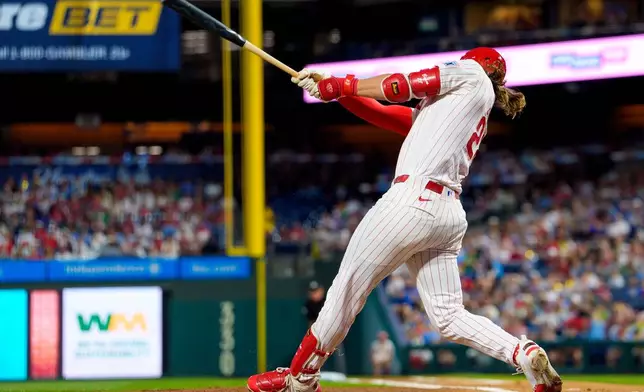 Philadelphia Phillies' Alec Bohm hits an RBI single during the first inning of a baseball game against the Los Angeles Dodgers, Tuesday, July 21, 2026, in Philadelphia. (AP Photo/Chris Szagola)