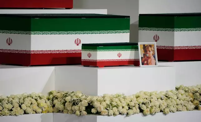The casket of slain Iranian Supreme Leader Ayatollah Ali Khamenei's granddaughter, Zahra Mohammadi Golpayegani, is displayed alongside the caskets of Khamenei and other members of his family during a viewing ceremony ahead of the dayslong funeral ceremonies at the Imam Khomeini Mosalla Grand Mosque in Tehran, Iran, Friday, July 3, 2026. (AP Photo/Vahid Salemi)
