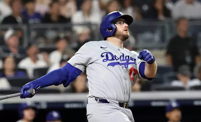 Los Angeles Dodgers' Max Muncy watches his two-run home run during the seventh inning of a baseball game against the New York Yankees, Friday, July 17, 2026, in New York. (AP Photo/Adam Hunger)