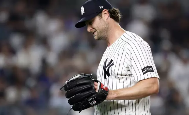 New York Yankees pitcher Gerrit Cole reacts while walking to the dugout after giving up a two-run home run to Los Angeles Dodgers' Max Muncy during the seventh inning of a baseball game Friday, July 17, 2026, in New York. (AP Photo/Adam Hunger)