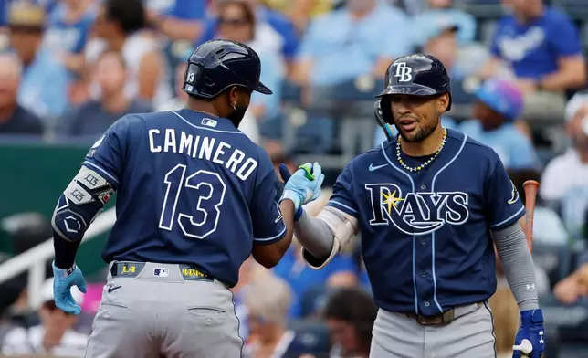Tampa Bay Rays' Junior Caminero (13) celebrates his two-run home run with Victor Mesa Jr., right, during the first inning of a baseball game against the Kansas City Royals in Kansas City, Mo., Wednesday, July 1, 2026. (AP Photo/Colin E. Braley)