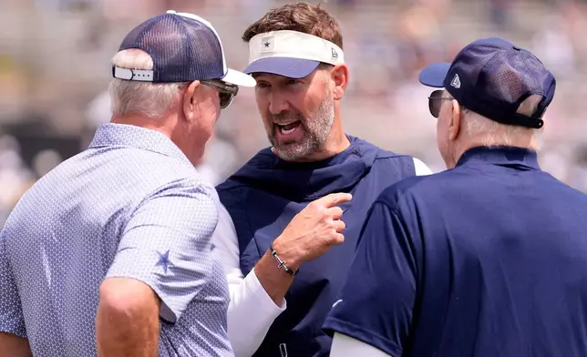 Dallas Cowboys co-owner, executive vice president, CEO, and director of player personnel Stephen Jones, left, chats with head coach Brian Schottenheimer, center, and Cowboys owner, president and general manager Jerry Jones during the NFL football team's training camp, Wednesday, July 29, 2026, in Oxnard, Calif. (AP Photo/Mark J. Terrill)
