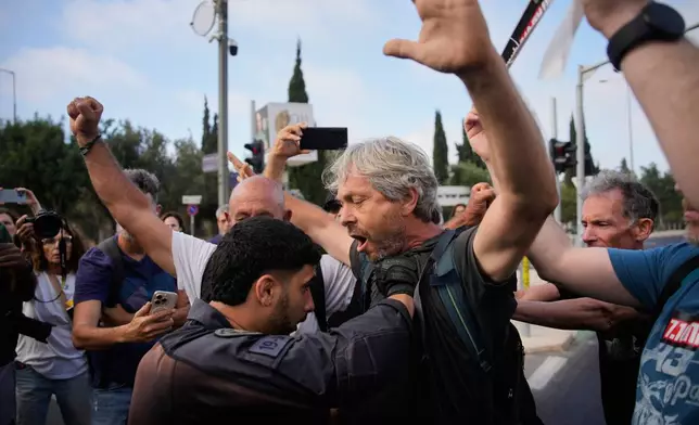 Police disperse demonstrators during a protest marking 1,000 days since the Oct. 7 2003 Hamas-led attack on Israel, outside of the Knesset, Israel's parliament, in Jerusalem, Thursday, July 2, 2026. (AP Photo/Ohad Zwigenberg)