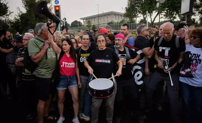 People protest outside the Knesset, Israel's parliament, in Jerusalem, marking 1,000 days since the Oct. 7, 2023, Hamas-led attack on Israel, Thursday, July 2, 2026. (AP Photo/Ohad Zwigenberg)