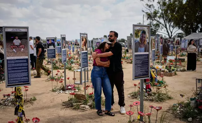 FILE - People mark Israel's annual Memorial Day at the site of the Nova music festival, where hundreds of revelers were killed and abducted in the Oct. 7, 2023 Hamas attack, near Kibbutz Reim in southern Israel, April 21, 2026. (AP Photo/Ohad Zwigenberg, File)