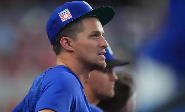 Texas Rangers' Corey Seager looks on from the dugout during a baseball game against the Seattle Mariners, Sunday, July 26, 2026, in Arlington, Texas. (AP Photo/LM Otero)