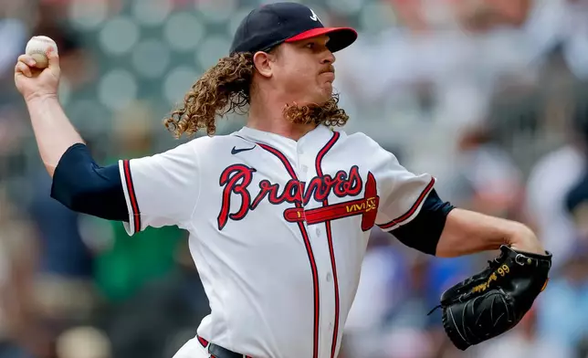 Atlanta Braves pitcher Grant Holmes delivers to a Texas Rangers batter during the first inning of a baseball game, Sunday, July 19, 2026, in Atlanta. (AP Photo/Erik S. Lesser)