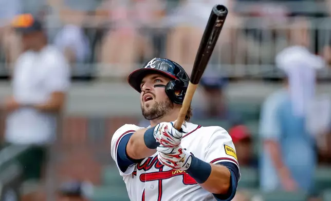 Atlanta Braves' Austin Riley follows through on a solo home run against the Texas Rangers during the second inning of a baseball game, Sunday, July 19, 2026, in Atlanta. (AP Photo/Erik S. Lesser)