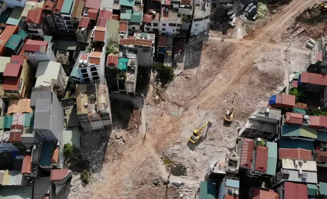 This aerial shot shows a ring road being built, cutting through a residential community in Hanoi, Vietnam, Monday, June 15, 2026. (AP Photo/Hau Dinh)
