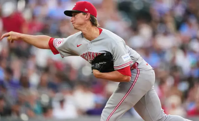 Cincinnati Reds starting pitcher Brady Singer works against the Colorado Rockies in the first inning of a baseball game Friday, July 17, 2026, in Denver. (AP Photo/David Zalubowski)