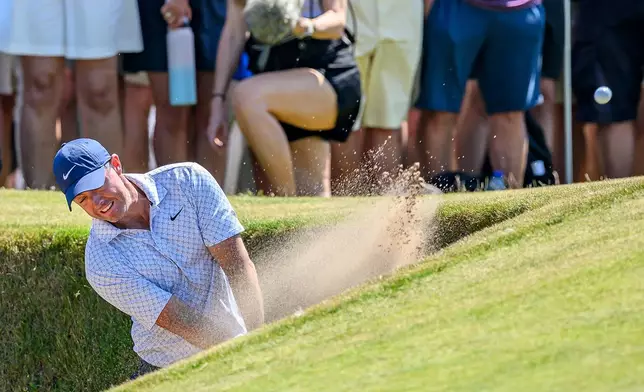 Rory McIlroy, of Northern Ireland, plays from a bunker on the ninth fairway during day one of the Genesis Scottish Open 2026 at The Renaissance Club in North Berwick, Scotland, Thursday, July 9, 2026. (Malcolm Mackenzie/PA via AP)