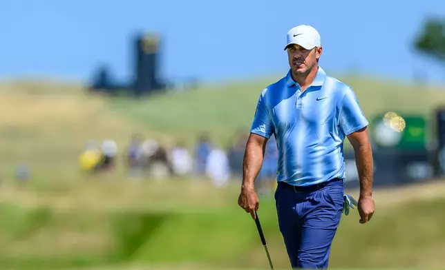 Brooks Koepka, of the United States, walks to the ninth green during day one of the Genesis Scottish Open 2026 at The Renaissance Club in North Berwick, Scotland, Thursday, July 9, 2026. (Malcolm Mackenzie/PA via AP)