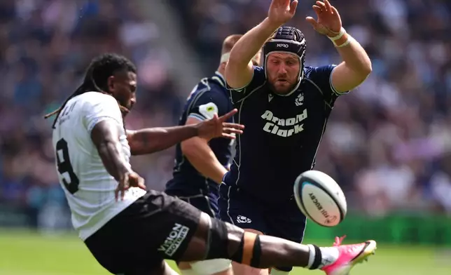 Fiji's Frank Lomani performs a box kick that is charged down by Scotland's George Horne during the Nations Championship match between Scotland and Fiji, at Scottish Gas Murrayfield Stadium in Edinburgh, Scotland, Saturday July 18, 2026. (Andrew Milligan/PA via AP)