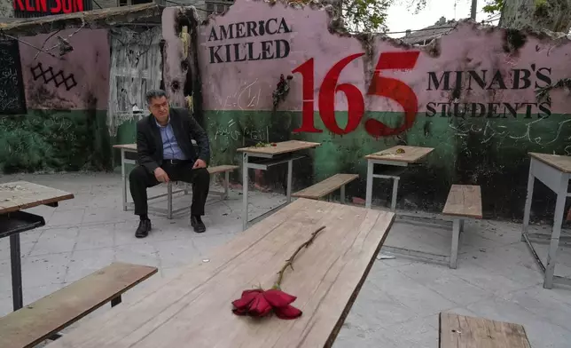 FILE - A man sits on a bench in a memorial, set for the school children who were killed during a strike on a primary school in southern town of Minab on Feb. 28, in northern Tehran, Iran, Sunday, April 12, 2026. (AP Photo/Vahid Salemi, File)