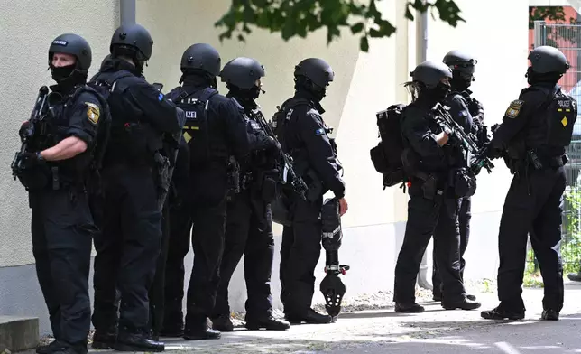 Heavily armed police officers guard at the Welfen High School, Schongau, Germany, Wednesday, July 8, 2026. (Lennart Preiss/dpa via AP)