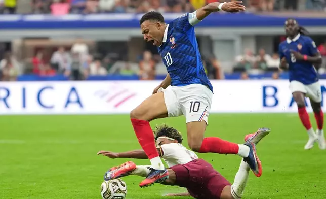 Spain's Lamine Yamal and France's Kylian Mbappe (10) vie for the ball during a World Cup semifinal soccer match in Arlington, Texas, near Dallas, Tuesday, July 14, 2026. (AP Photo/Julio Cortez)