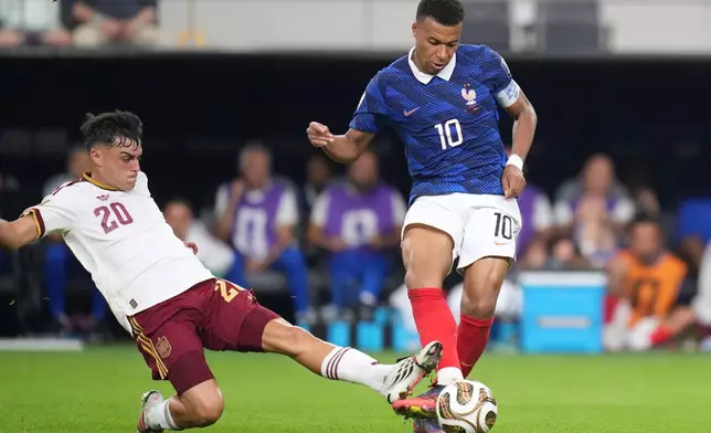 Spain's Dani Olmo (10) tries to poke the ball away from France's Kylian Mbappe (10) during the World Cup semifinal soccer match between France and Spain in Arlington, Texas, near Dallas, Tuesday, July 14, 2026. (AP Photo/Eric Gay)
