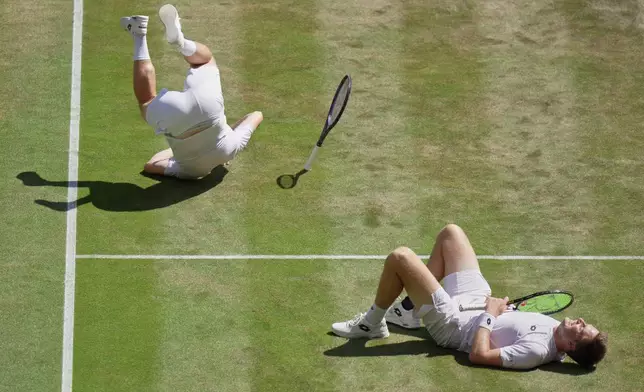Harri Heliovaara of Finland, left and playing partner Henry Pattern of Britain react after defeating Marcelo Arevalo of Spain, and Mate Pavic of Croatia, in the men's doubles final at Wimbledon Tennis Championships in London, Saturday, July 11, 2026. (AP Photo/Brian Inganga)