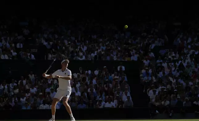 Jannik Sinner of Italy plays a return to Alexander Zverev of Germany men's singles final at Wimbledon Tennis Championships in London, Sunday, July 12, 2026. (AP Photo/Kin Cheung)