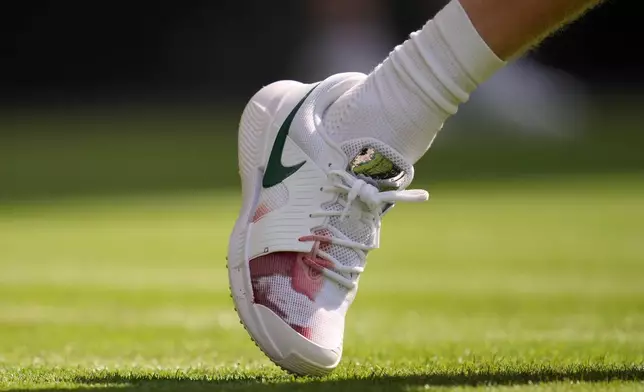 Italy's Jannik Sinner's right shoe shows a red stain during the men's singles match against Miomir Kecmanovic of Serbia at the Wimbledon Tennis Championships in London, Monday, June 29, 2026.(AP Photo/Kin Cheung)