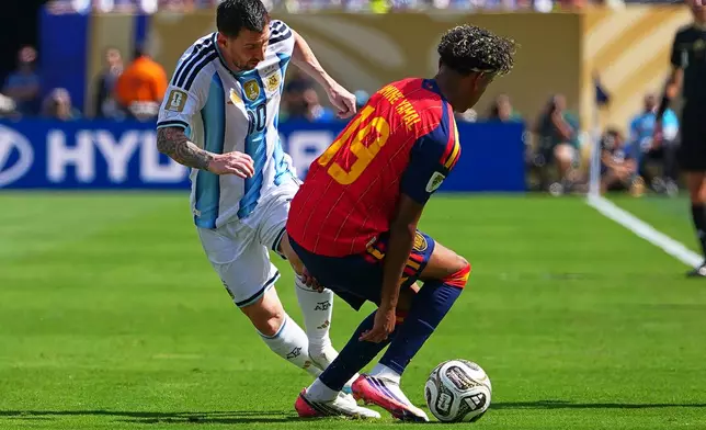 Argentina's Lionel Messi (10) vies for the ball with Spain's Lamine Yamal (19) during the World Cup final soccer match between Spain and Argentina in East Rutherford, N.J., near New York, Sunday, July 19, 2026. (AP Photo/Julio Cortez)